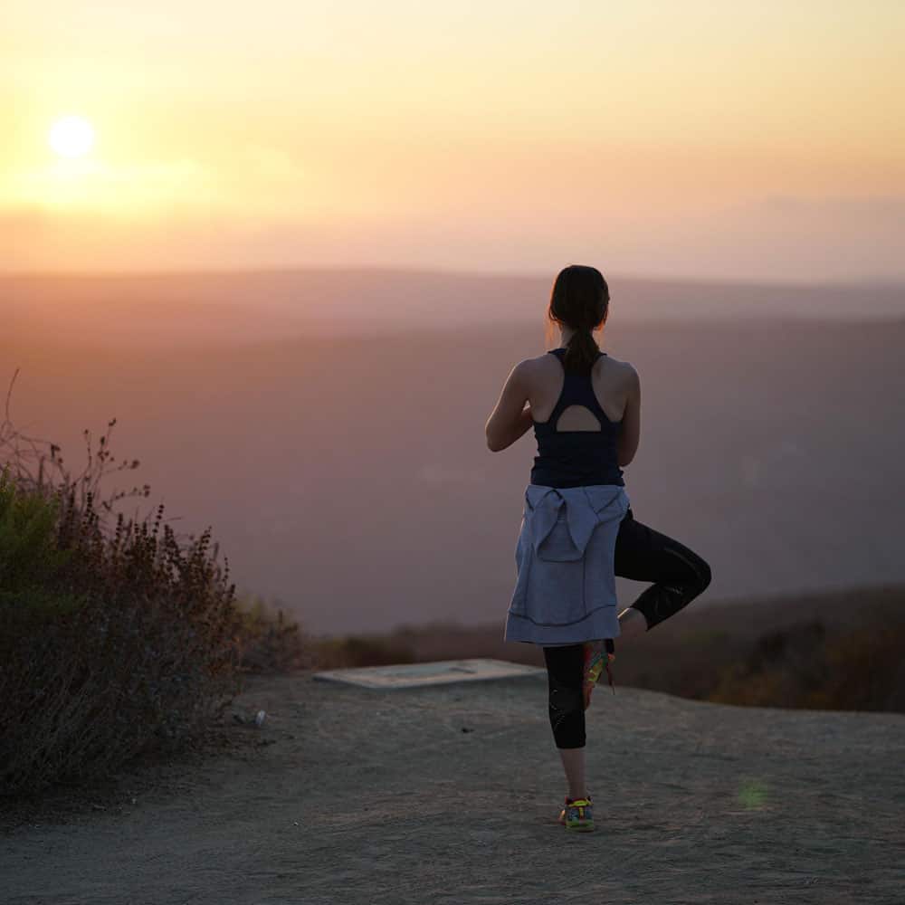 Lady doing yoga at sunset in Bali